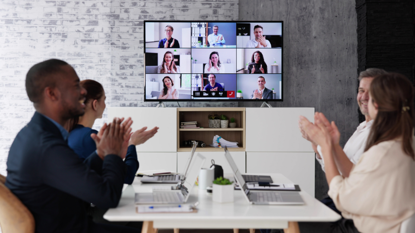 People watching a live event in a hybrid meeting room